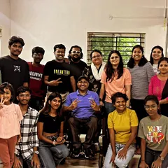 A group photo of our amazing volunteers after a productive crafting session at Eka. You can see the mix of people of all ages and abilities, including a participant in a wheelchair, all united for a common cause.
