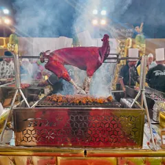 The centerpiece of our live barbecue station, a whole tandoori-spiced goat slow-roasting over charcoal. The sight and smoky aroma create an interactive and theatrical dining experience that guests talk about long after the event.