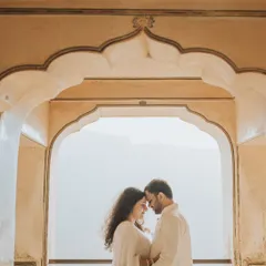 Framed by the beautiful arches of a Rajasthani palace, this couple shares a quiet, intimate moment. We use architectural elements to create naturally beautiful compositions that highlight your connection.