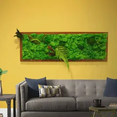 Moss art is a perfect way to bring nature into your living room. This framed piece, filled with various types of preserved moss and ferns, hangs above the sofa like a painting, adding texture and a calming, natural element.