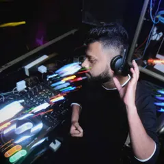 Feeling the vibe. The long exposure light trails in this photo capture the motion and energy of a live set. This is me completely absorbed in the music, creating a dynamic audio-visual experience.