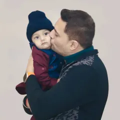 A father gives his baby a gentle kiss on the cheek. We focus on capturing these simple, heartfelt gestures that convey so much love.