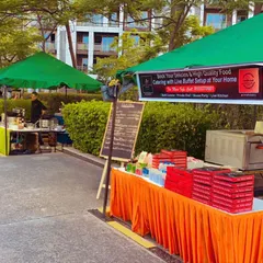 Our food stall at a Tata Premanti event. The banner clearly states our offering: delicious, high-quality food with live buffet setup at your home, showcasing our versatility for both large events and private parties.