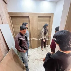Exploring the interior details during a site visit. I am here with my team, discussing the woodwork and ensuring functionality in every corner.