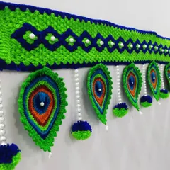 I love making these peacock feather or 'Mor Pankh' torans. The rich blues and greens, combined with delicate pearl beads, create a vibrant and elegant look for any main door or pooja room entrance.