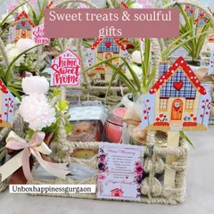 A close-up of the housewarming basket, showing the 'Home Sweet Home' tag, a personalized card, and the mix of soulful gifts inside.
