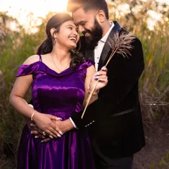 Pure happiness and love captured in a single frame. This couple's coordinated outfits, a purple gown and a black blazer, look stunning in the warm, glowing sunlight.