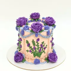 Another view of the purple and peach vintage cake, showing the detailed swags and shell borders.