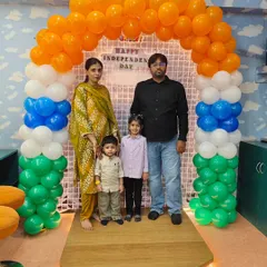 A family poses for a picture in front of our custom Independence Day photo booth. We provide beautiful, themed backdrops so you can capture precious memories during our festive events.