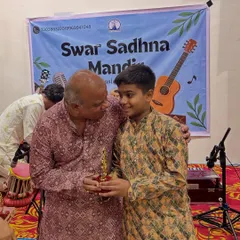 A proud moment for our student as he receives his trophy. Recognizing and rewarding their talent is a huge part of encouraging them on their musical journey.