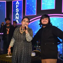 On stage with the powerful singer Afsana Khan during her performance. I am always present to support the artist and manage the show's flow.