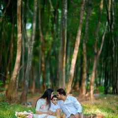 In the middle of a forest clearing, we captured this intimate family moment. The father's gentle kiss and the mother's loving gaze create a powerful image of the close bonds we aim to highlight in our family photography.