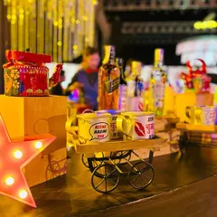 A close-up of the quirky details from my Bollywood bar. A hand-painted kettle and mugs with dialogues like "Kitne aadmi the?" sit on a decorative cart, creating perfect photo opportunities for your guests.