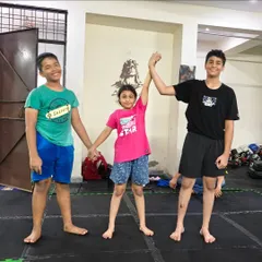 The process of learning is a team effort. These students stand together, supporting each other's growth in our kids' MMA program.