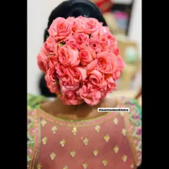 A classic floral bun is always a stunning choice for a traditional event. This hairstyle features a full bun covered in beautiful pink roses, creating a bold and romantic statement from the back.