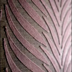 A close-up of the embroidered texture on our Ornamenta wallcovering. The raised, satin-finish stitching on a linen-like background creates a rich, tactile experience that speaks of pure luxury.