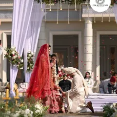 A beautiful moment from a wedding we planned, with the groom on one knee. The elegant white mandap is decorated with subtle floral arrangements, creating a timeless and romantic backdrop for the ceremony.