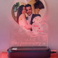 An elegant heart-shaped crystal lamp that holds your photo. The LED base lights up the engraved names and "Happy Anniversary" message, creating a romantic glow.