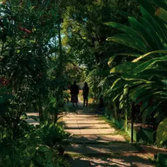Two guests enjoying a leisurely walk along one of our green pathways. It's moments like these, spent in nature, that define the Holiday Village experience.