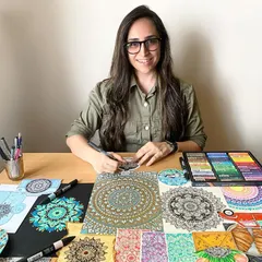 Here I am at my desk, surrounded by some of my favorite creations. My workspace is where ideas turn into art, using everything from fine-tipped pens and markers to pastels.