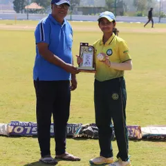 A player receives her "Woman of the Match" trophy during a competitive tour, recognizing her outstanding contribution.