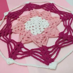 A close-up view of the center of the Karamella doily, highlighting the detailed stitch work and color changes.