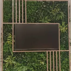 For the Biba showroom, we designed and installed this custom artificial green wall that frames a media screen, blending technology with nature for a unique and engaging retail environment.