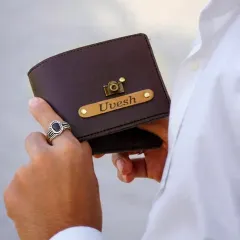 A gift that he will carry with him always. This is a close-up of my personalized leather wallet, customized with a name and a camera charm, showing the fine quality and personal touch that makes it special.