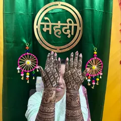 A fun pose from a happy bride, showing the back of her hands. The design features elephant motifs, a popular choice for bridal mehendi.