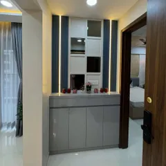 This entryway unit features a mirrored and paneled back wall with integrated lighting, adding a touch of glamour and making the space feel brighter.