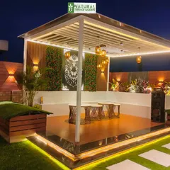 The completed pergola and seating area in our Shahdara project. The space features a vertical garden, custom art, and layered lighting for a modern and eclectic vibe.