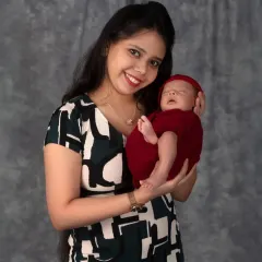 A new mother's radiant smile as she holds her baby. My goal is to make every mama feel beautiful and celebrated as I capture the incredible bond she shares with her child.