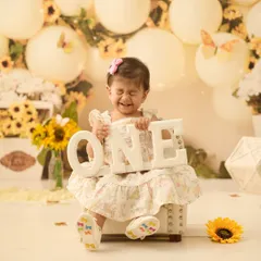 Capturing the pure, unscripted joy of turning one. This little one's expression is priceless against our bright and cheerful sunflower backdrop.