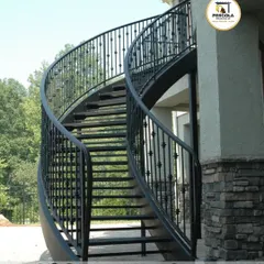 An elegant, free-standing curved metal staircase designed for an exterior space. The smooth curves and detailed balusters demonstrate our precision fabrication skills, creating a timeless architectural feature that adds grace and value to the property.