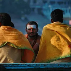 On a boat in the Ganges, I captured this moment of three men, their backs to the camera, with one looking directly at me. The tilak on his forehead and the yellow shawls tell a story of faith and tradition against the calm waters of Varanasi.