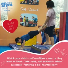 Teamwork makes the dream work. Here, one child supports another in a 'wheelbarrow' exercise, a great activity for building trust, communication, and core strength.