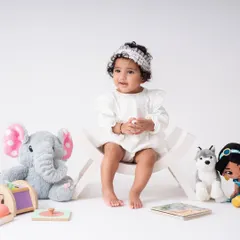A wider shot of the sitter session setup. I use simple, clean backgrounds and a few favorite toys to create a space where the baby is the star of the show.