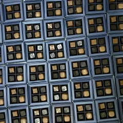 Gifting never tasted so divine. This image shows a large order of our four-piece assorted chocolate boxes, perfect for corporate events or wedding favors.
