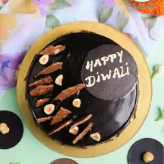 Celebrate Diwali with our indulgent Hazelnut Truffle Cake. This rich, glossy chocolate cake is topped with crunchy hazelnuts and a festive "Happy Diwali" message, offering a modern and luxurious centerpiece for your celebrations.