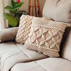 There's nothing like adding texture to a room with handmade cushion covers. These macrame pillow cases, shown here on a comfy sofa, feature two different intricate knot patterns. They are perfect for giving your living room or bedroom a cozy, boho-chic feel.