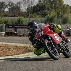 A rider demonstrates perfect cornering form, leaning deep into the turn. Our track's 14 corners are designed to help you practice and perfect your body positioning and technique.