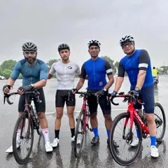 A group of riders celebrating a member's birthday after a rainy ride. Our team's dedication shines through, no matter the weather.