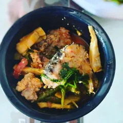A traditional Manipuri fish curry cooked with bamboo shoots. The bamboo gives the dish a unique aroma and a slightly tangy taste that complements the fish perfectly.