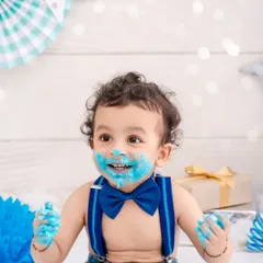 Nothing beats the pure joy of a first birthday cake smash. This little boy, with his bright blue bow tie and even brighter smile, is having the best time making a happy mess. These sessions are all about capturing that uninhibited, playful spirit.