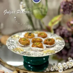 The Gulzar Platter, shown here serving delicious mithai. This luxury silver-coated platter with an emerald green velvet base is a beautiful piece