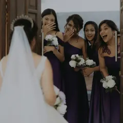 The pure, unfiltered joy and surprise on the bridesmaids' faces during the bride's reveal.