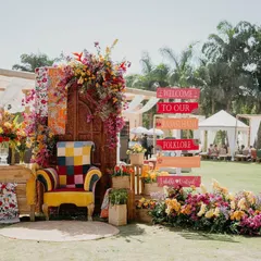 For this Mehendi, we created a modern Rajasthani folklore theme. This vibrant photo-op, with its colorful signage and a quirky, patchwork armchair, became the heart of the celebration. It’s not just a backdrop; it’s a whole vibe.