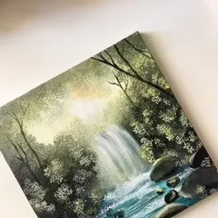 The finished painting of the sunlit waterfall, showing the light filtering through the trees and hitting the water. This piece is all about capturing that magical forest glow.