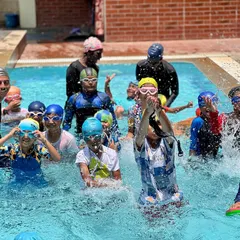 A snapshot of the energy and fun from one of our regular swimming classes. You can see our coaches right in the water with the kids, making a splash and learning together.