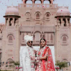 A moment of pure celebration. We live for these unscripted showers of joy, capturing the energy of your big day as you stand together against the magnificent backdrop of the Laxmi Niwas Palace.